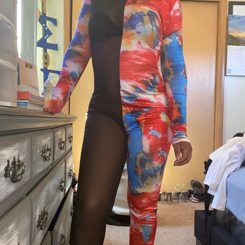 Multicolored jump suit, zips in the back.